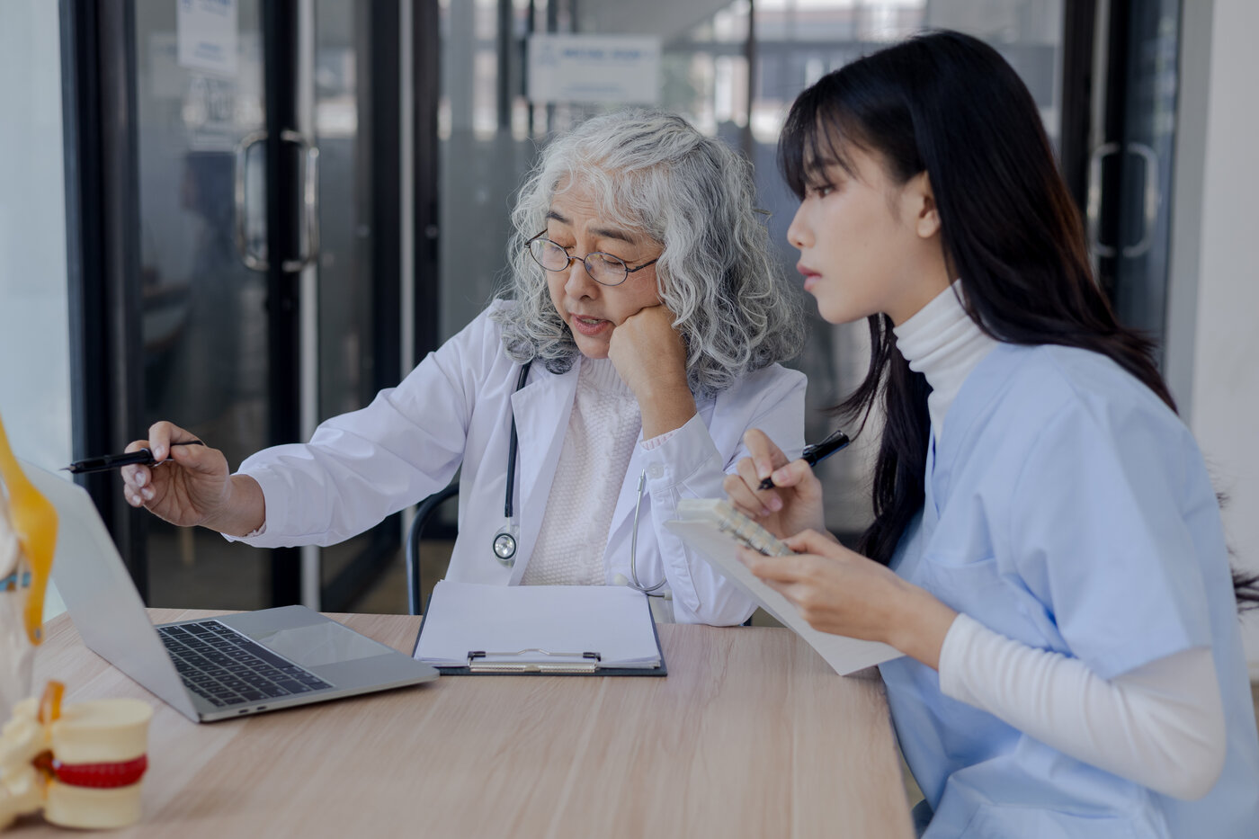 Senior physician reviewing information with a colleague
