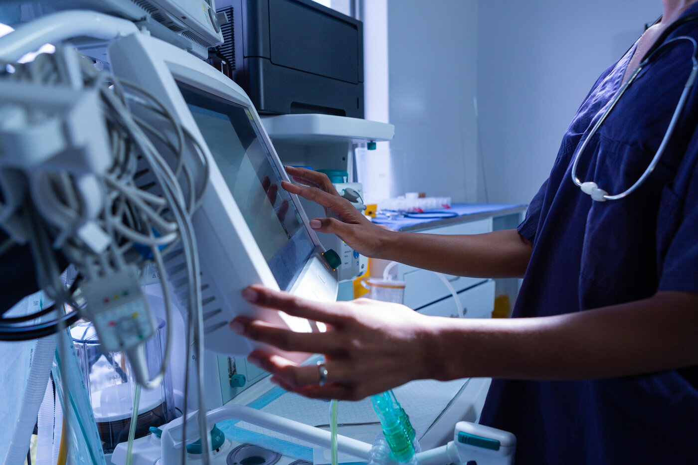 Clinician operating medical equipment in a hospital setting